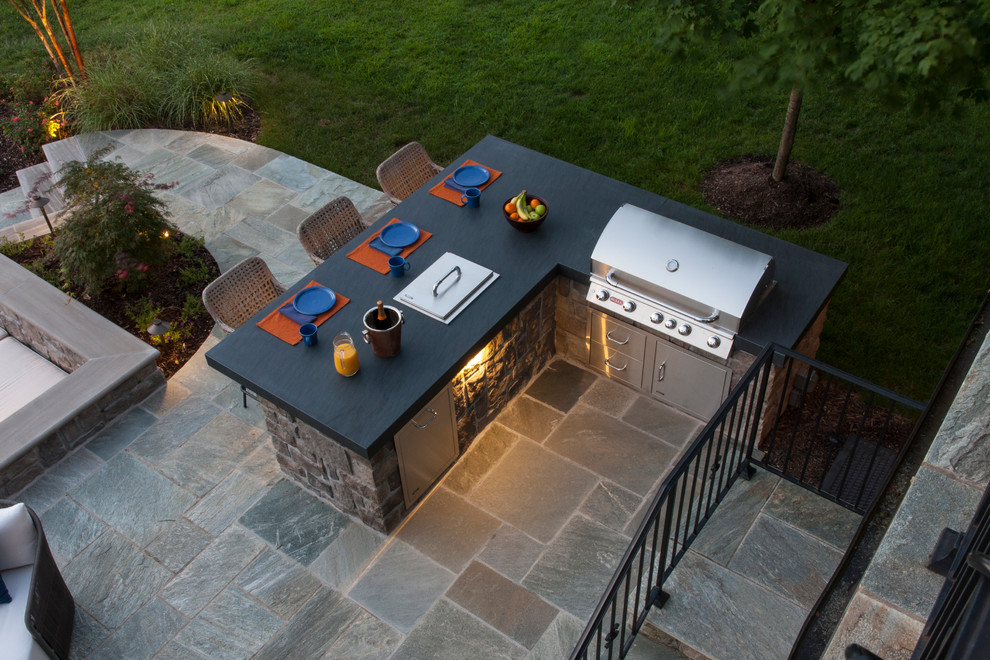 Medium sized modern back patio in DC Metro with an outdoor kitchen, stamped concrete and no cover.