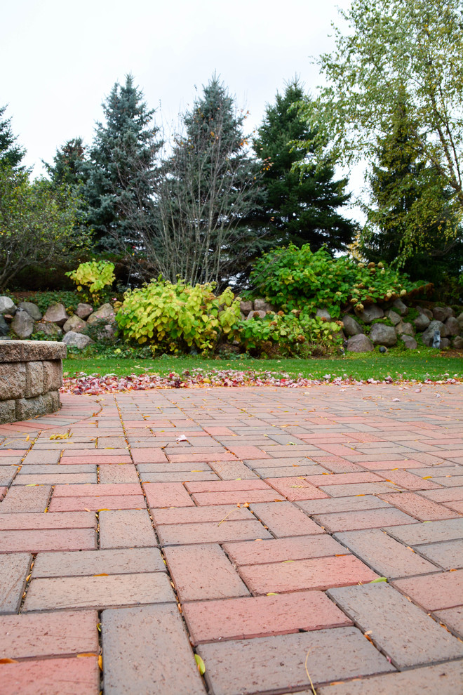 Inspiration for a modern back patio in Chicago with brick paving.