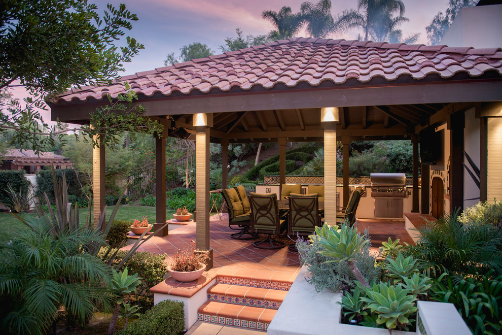 Design ideas for a large mediterranean back patio in Los Angeles with an outdoor kitchen, tiled flooring and a gazebo.