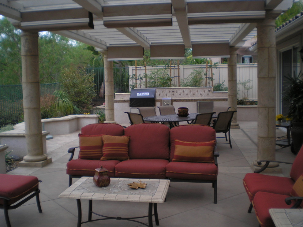 Design ideas for a large mediterranean back patio in San Diego with tiled flooring and a pergola.
