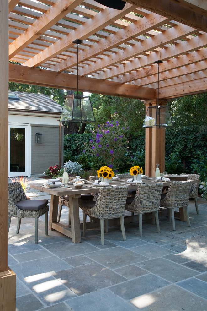 This is an example of a large contemporary back patio in San Francisco with tiled flooring and a gazebo.