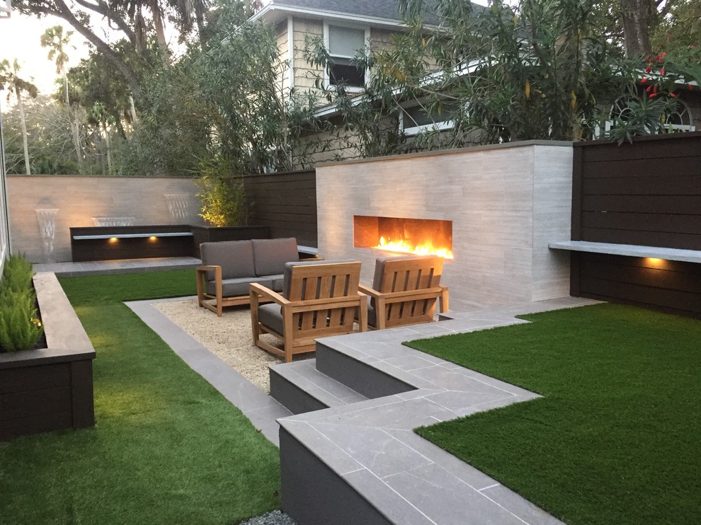 Photo of a small modern back patio in Jacksonville with no cover, a water feature and decomposed granite.