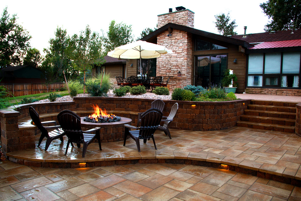 Mid-sized transitional backyard stone patio photo in Denver with a fire pit and no cover