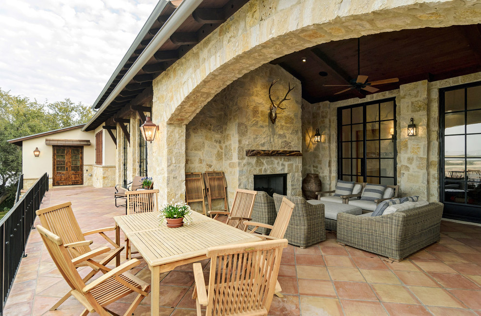 Example of a mountain style patio design in Austin with a fire pit