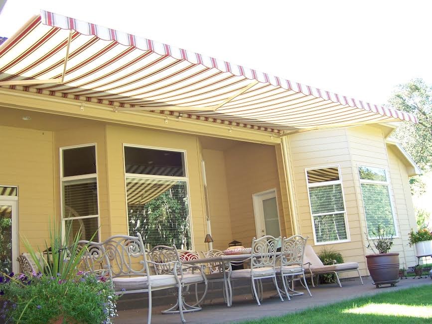 Immagine di un patio o portico chic di medie dimensioni e dietro casa con lastre di cemento e un parasole