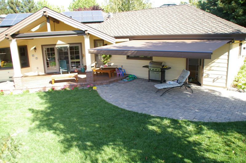 This is an example of a medium sized traditional back patio in Orange County with an awning and brick paving.