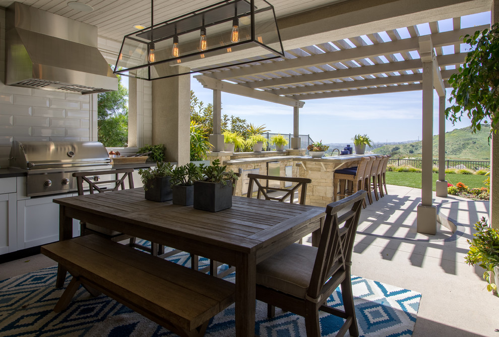 Inspiration pour une très grande terrasse arrière traditionnelle avec une cuisine d'été, une dalle de béton et une extension de toiture.