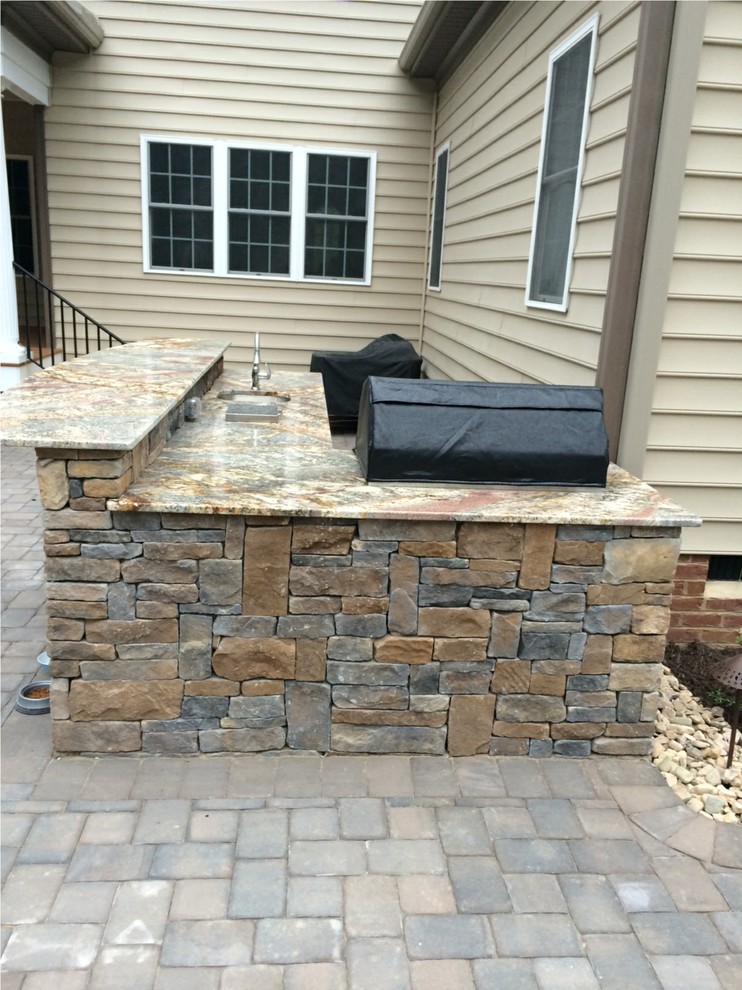 Photo of a large traditional back patio in Richmond with an outdoor kitchen and brick paving.
