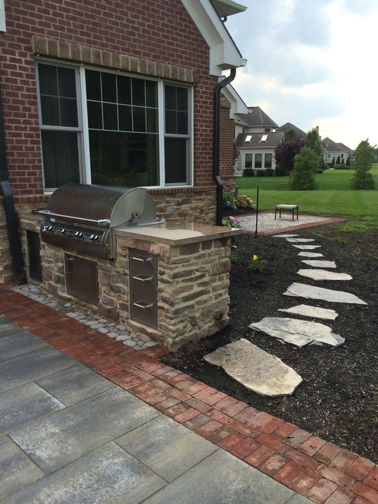 Large rustic back patio in Columbus with a fire feature, concrete paving and a gazebo.