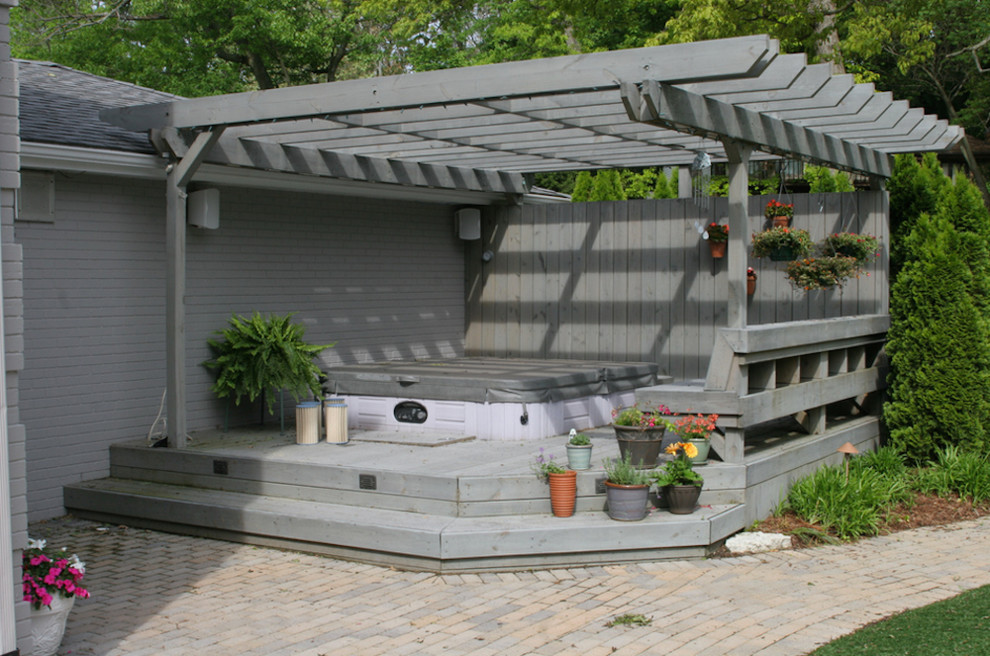 Example of a backyard patio fountain design in Indianapolis with a pergola