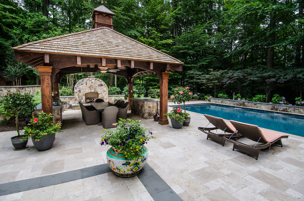 Diseño de patio de estilo americano grande en patio trasero con fuente, adoquines de piedra natural y cenador