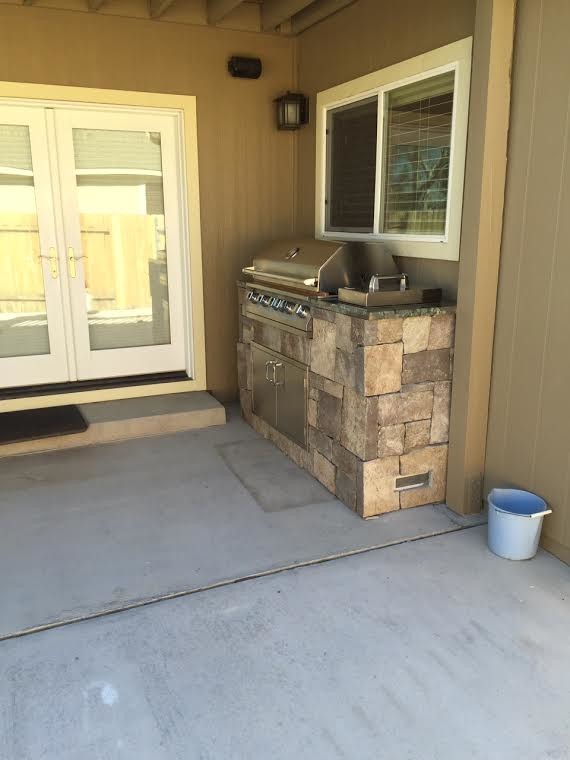 Mid-sized arts and crafts backyard concrete patio kitchen photo in Other with a roof extension