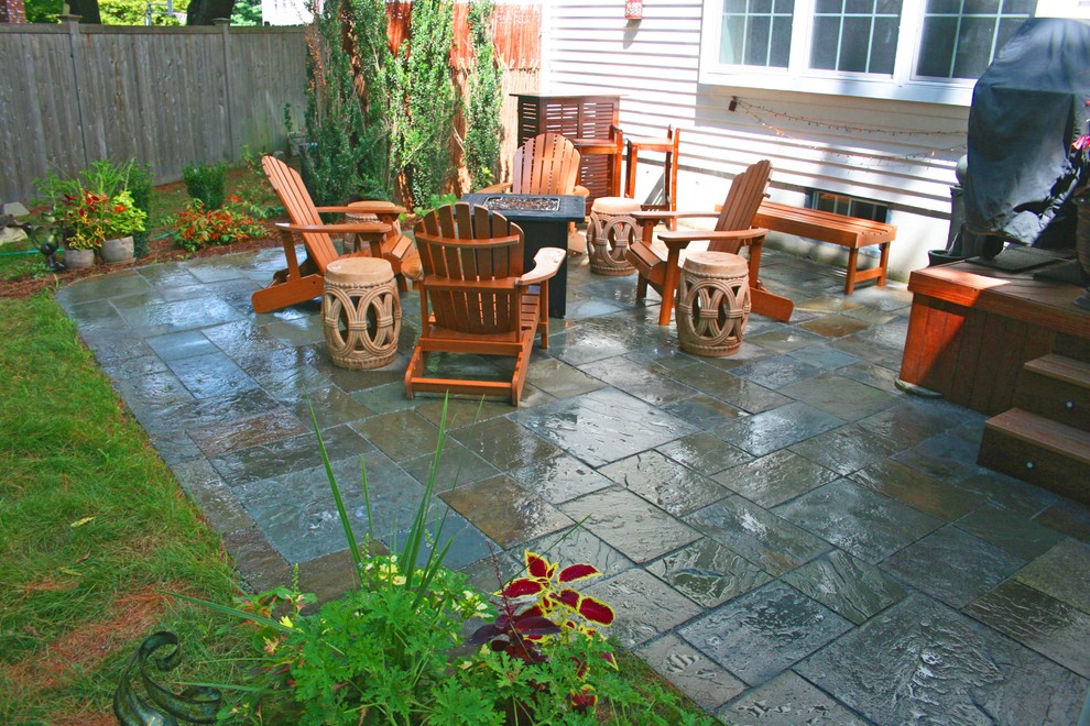 Photo of a small world-inspired back patio in Boston with natural stone paving and no cover.
