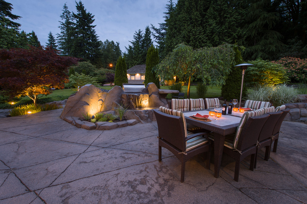 Medium sized classic back patio in Vancouver with an outdoor kitchen and stamped concrete.