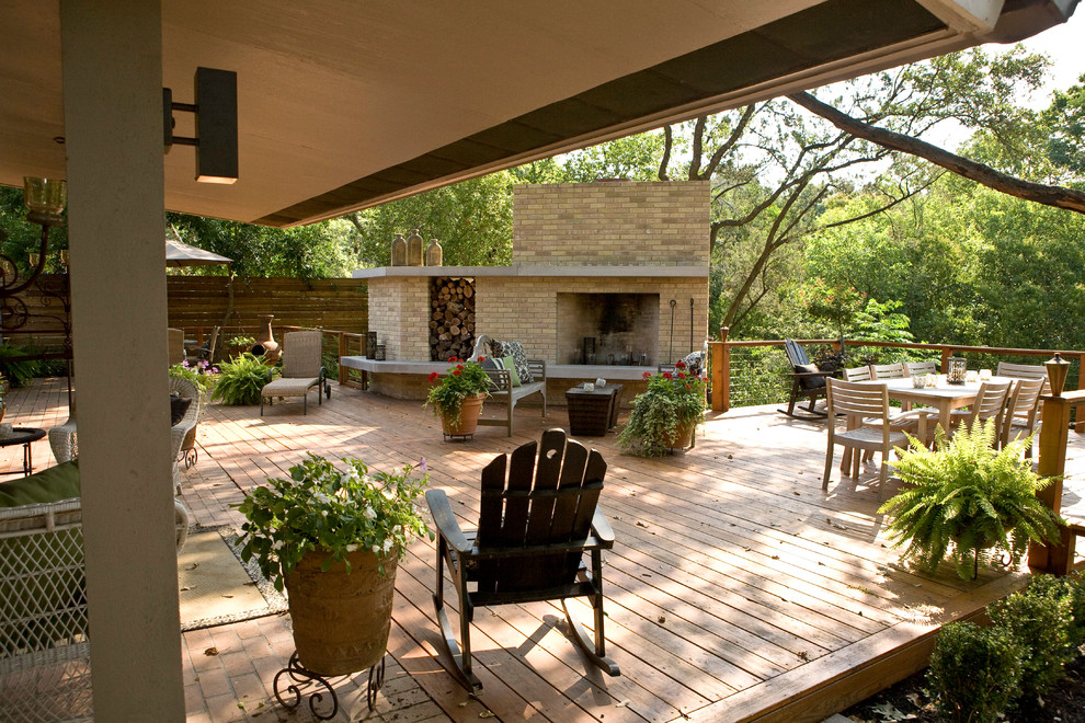 Inspiration for a large 1960s backyard patio remodel in Austin with a fire pit, decking and an awning
