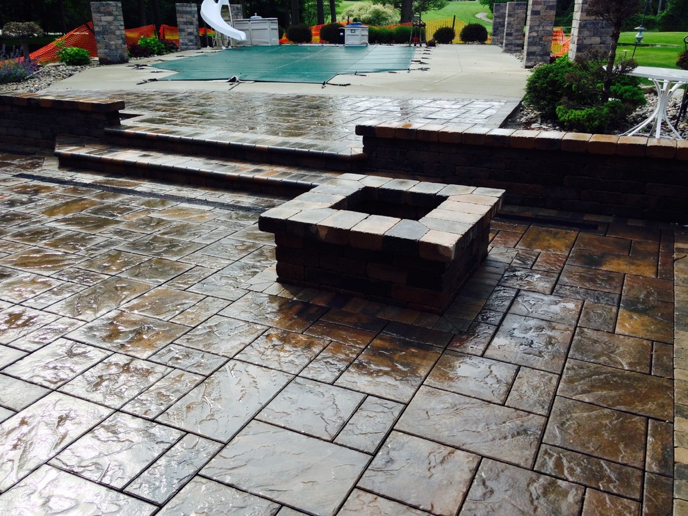 Medium sized contemporary patio in Other with a fire feature, concrete paving and no cover.
