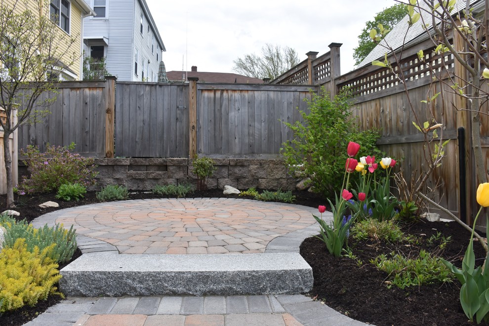 Inspiration for a small contemporary back patio in Boston with brick paving and no cover.