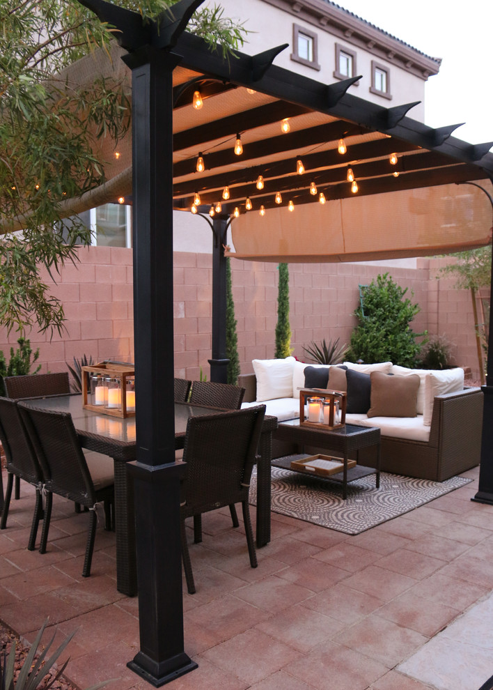 Small classic back patio in Las Vegas with concrete paving and a pergola.