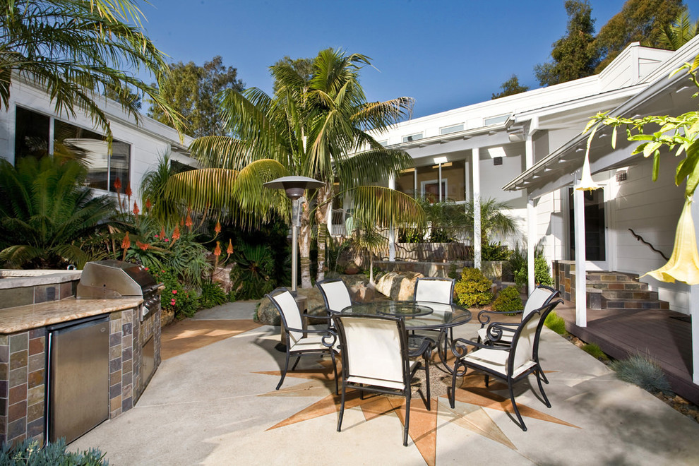 Mid-sized island style backyard concrete patio kitchen photo in San Diego with a roof extension