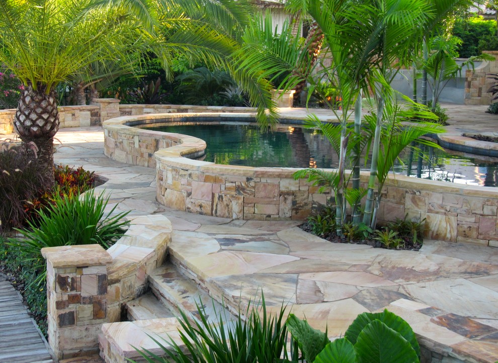 Design ideas for a mid-sized tropical landscaping in Miami.