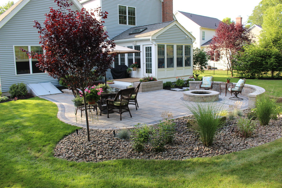 Inspiration for a small transitional backyard concrete paver patio remodel in Boston with a fire pit and no cover