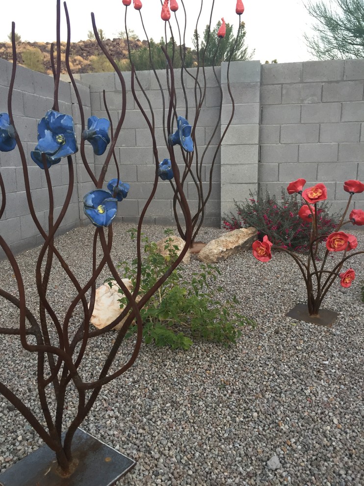 Medium sized back patio in Phoenix with gravel and no cover.