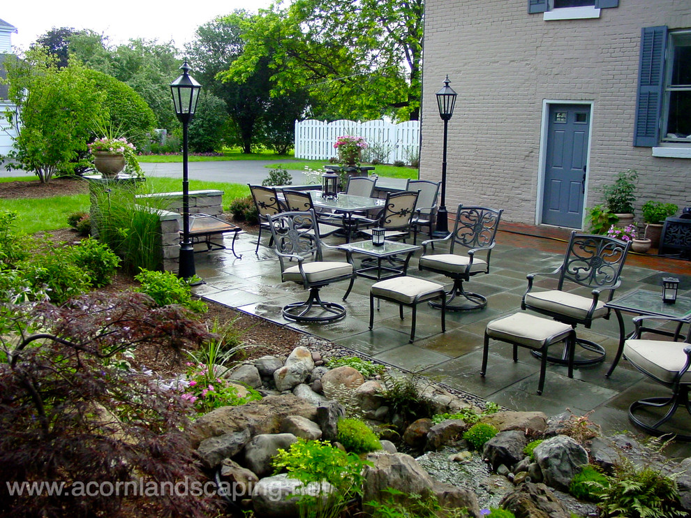 Inspiration for a classic patio in New York with natural stone paving.