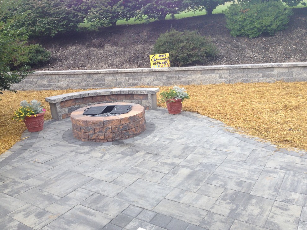 Mid-sized backyard concrete paver patio photo in Other with a fire pit and no cover