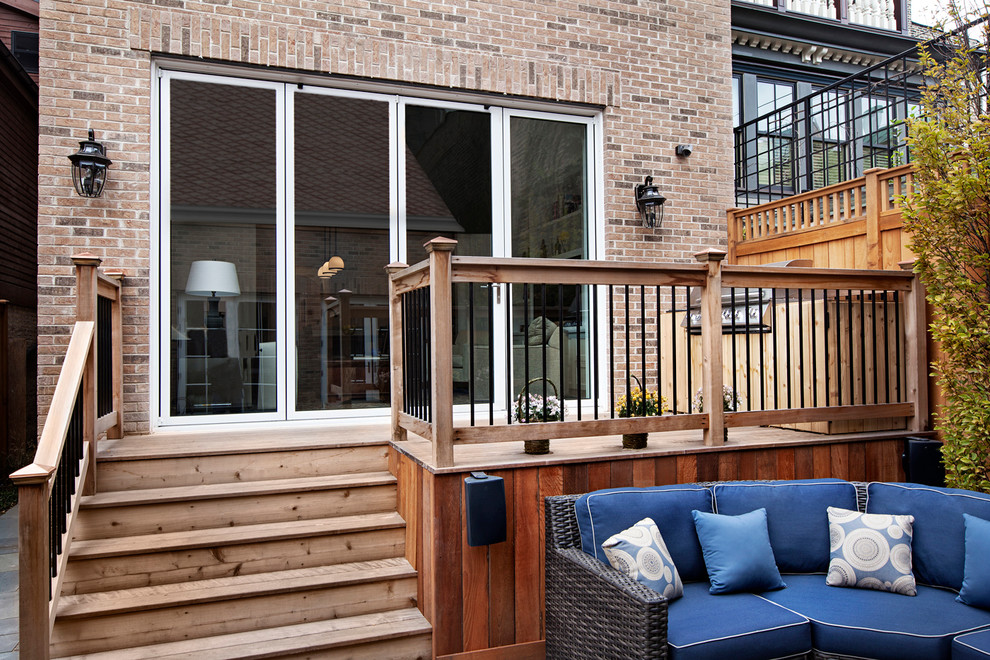 Large transitional backyard patio photo in Chicago with decking