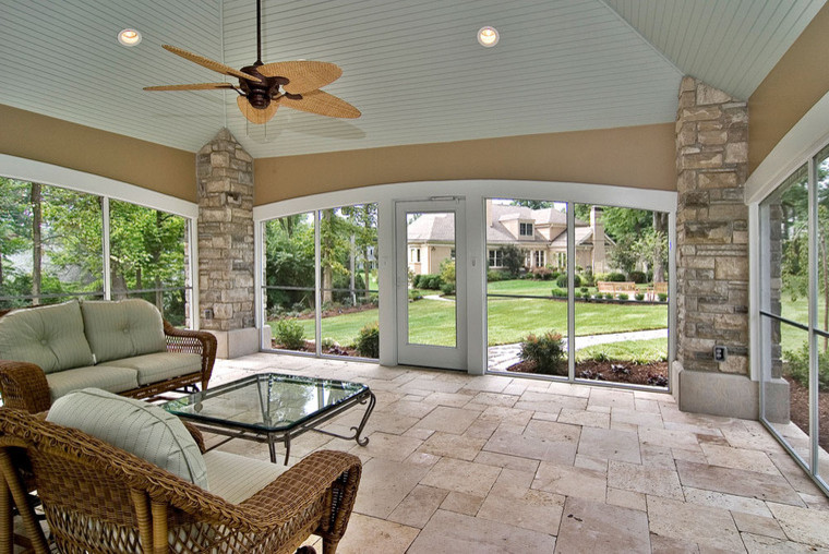 Large trendy backyard stone patio photo in St Louis with a gazebo
