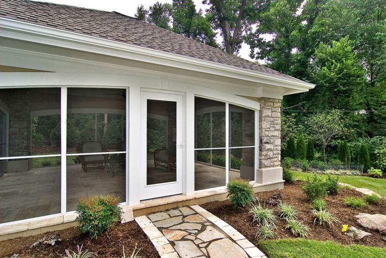 Inspiration for a large contemporary backyard stone patio remodel in St Louis with a gazebo