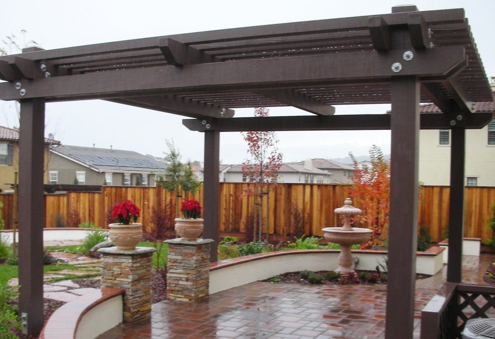 Example of a mid-sized classic backyard patio design in San Francisco with a pergola