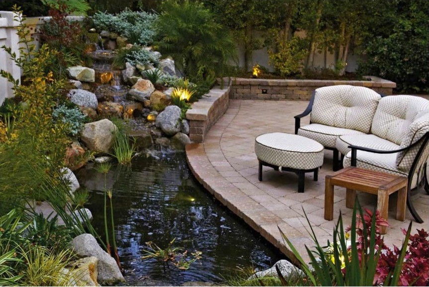 Patio - mediterranean backyard stone patio idea in Los Angeles with no cover