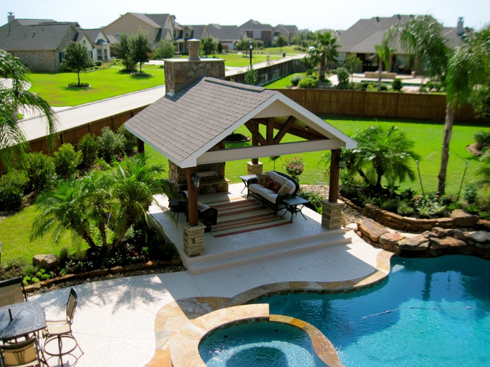 Mid-sized beach style backyard concrete patio photo in Houston with a fire pit and a gazebo