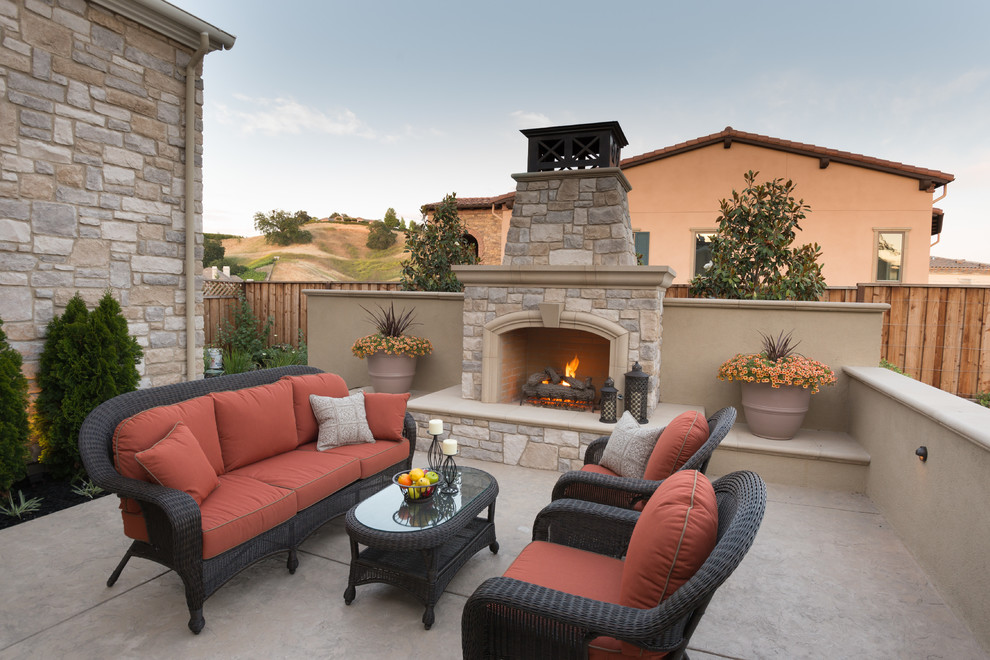 This is an example of a mediterranean patio in San Francisco with a fire feature and no cover.