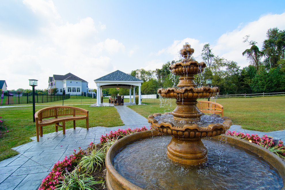 Inspiration for a huge transitional backyard stamped concrete patio kitchen remodel in DC Metro with a pergola