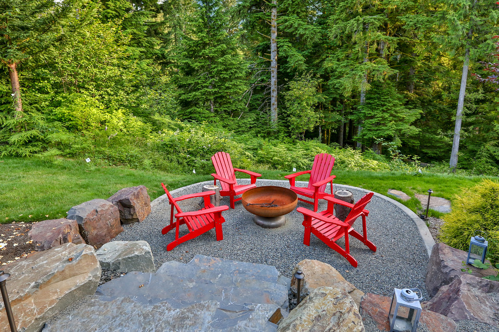 This is an example of a large classic back patio in Seattle with a fireplace, concrete paving and a gazebo.