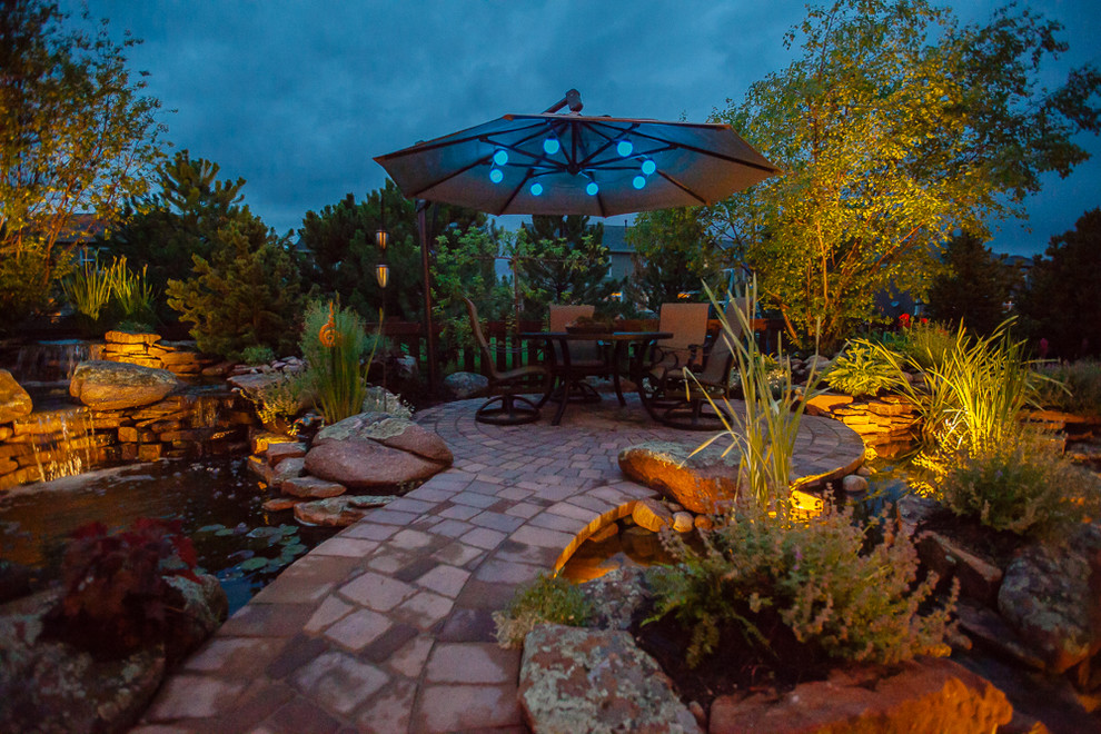 Large traditional back patio in Denver with an outdoor kitchen, concrete paving and a pergola.