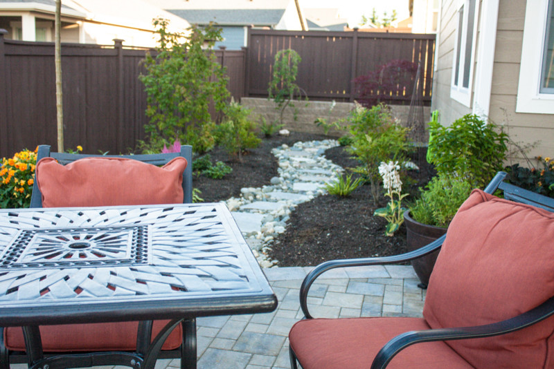 Patio - mid-sized traditional backyard brick patio idea in Seattle with no cover