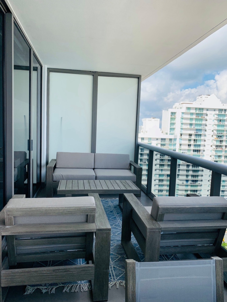 Large trendy concrete patio photo in Miami