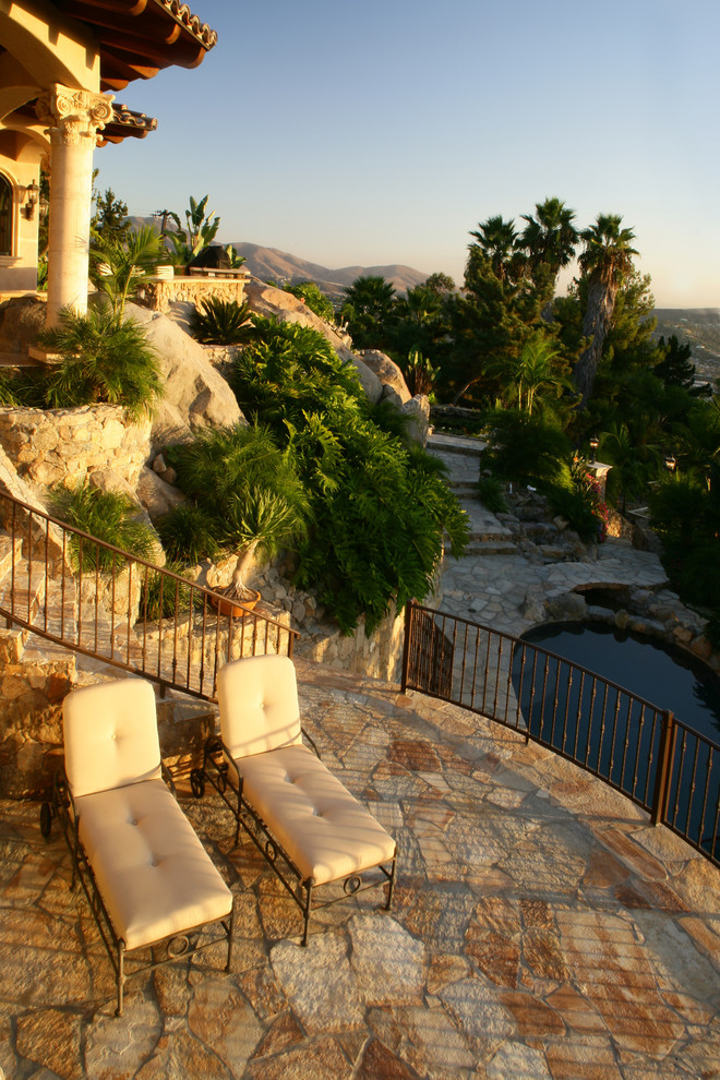 Идея дизайна: огромный двор на внутреннем дворе в средиземноморском стиле с покрытием из каменной брусчатки без защиты от солнца