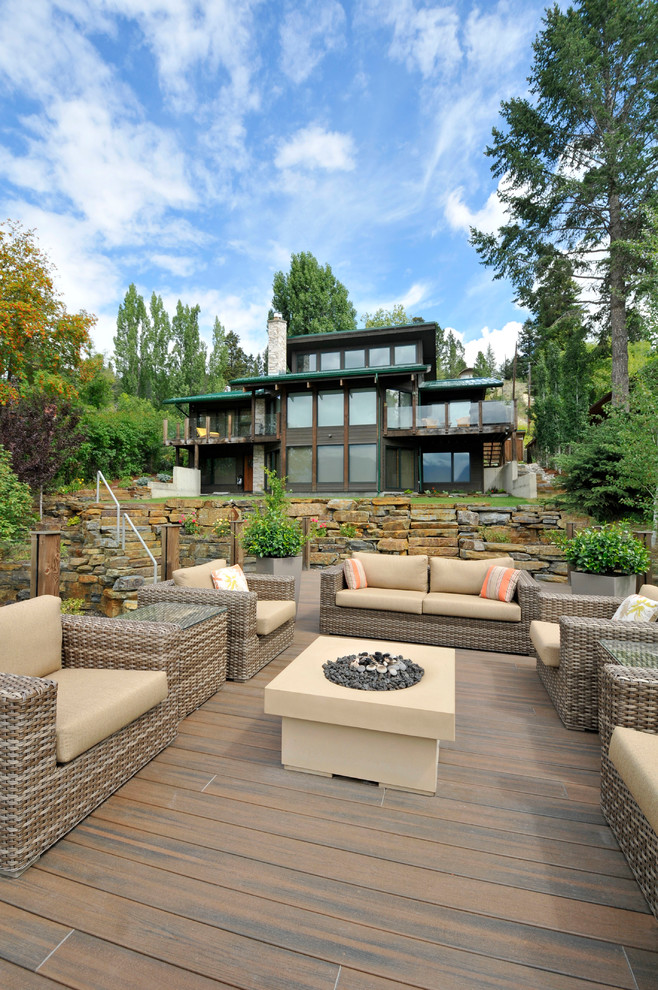 Example of a mid-sized mountain style backyard patio design in Vancouver with decking