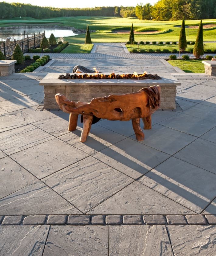 Inspiration for an expansive contemporary back patio in Philadelphia with a fire feature, concrete paving and no cover.
