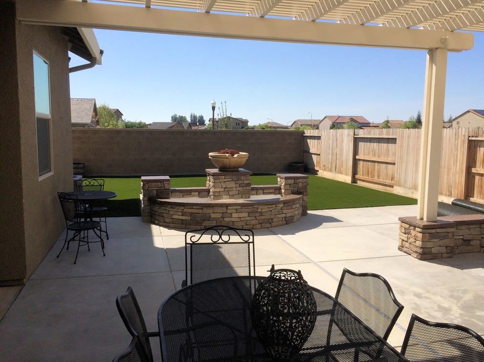 Design ideas for a large classic back patio in Austin with an outdoor kitchen, concrete slabs and a pergola.
