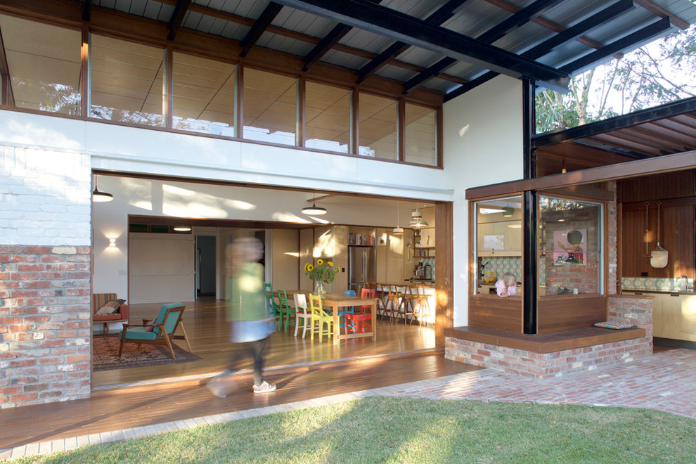 Design ideas for a medium sized contemporary back patio in Brisbane with an outdoor kitchen, brick paving and an awning.
