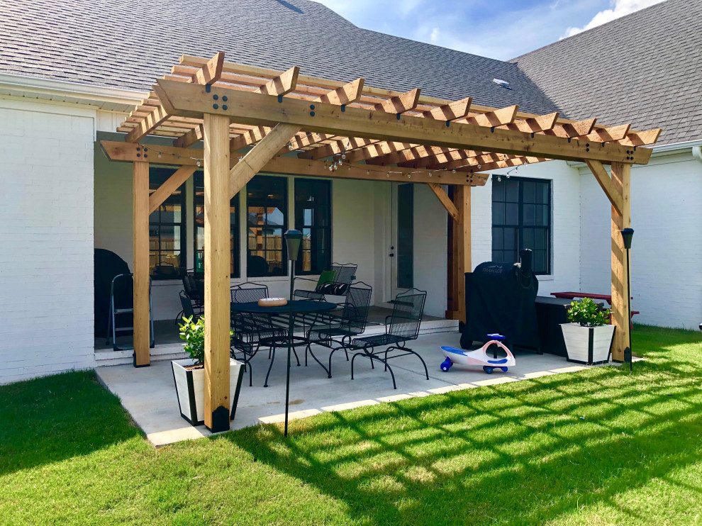 Patio - mid-sized cottage backyard concrete paver patio idea in Little Rock with a pergola