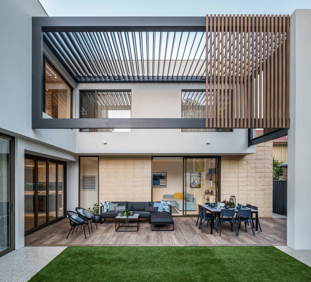 This is an example of a contemporary patio in Perth with tiled flooring and a pergola.