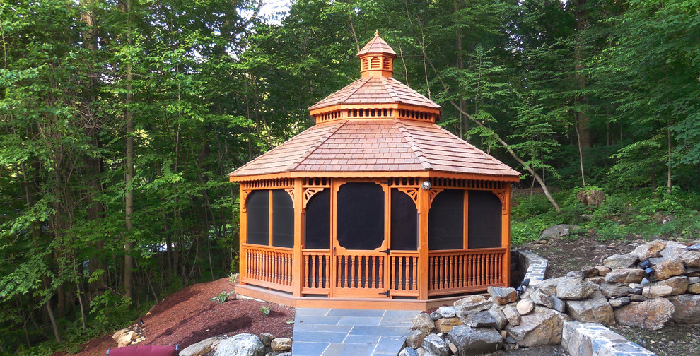 Patio - mid-sized traditional backyard stone patio idea in New York with a gazebo