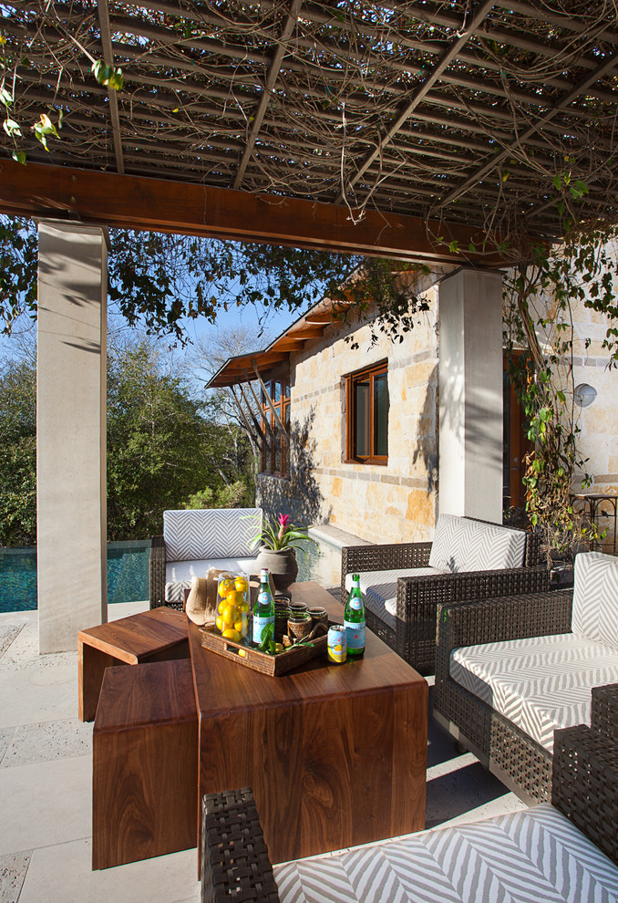 This is an example of a classic back patio in Austin with a pergola.