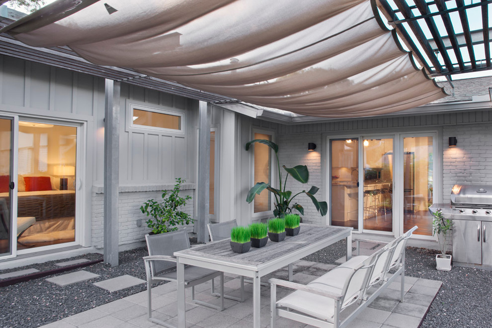 Свежая идея для дизайна: двор среднего размера на внутреннем дворе в современном стиле с козырьком, мощением тротуарной плиткой и зоной барбекю - отличное фото интерьера